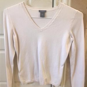 Very pale pink light weight long sleeved sweater.